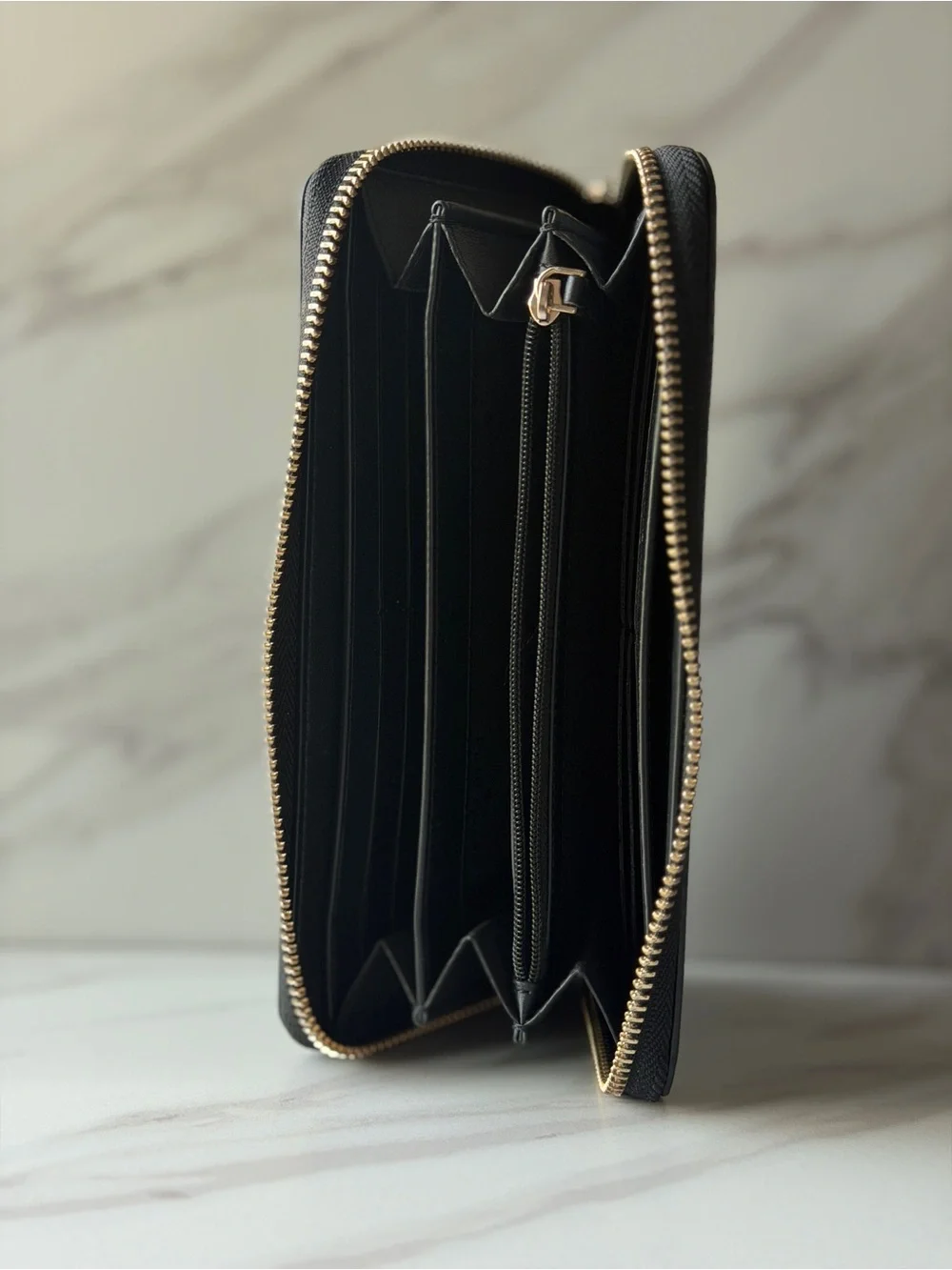 Kate Spade black saffiano leather zip-around continental wallet.